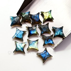 Könnte beinhalten: Eine Gruppe von 14 Labradorit-Edelstein-Cabochons in Sternform. Die Steine sind in einer Mischung aus Blau, Grün und Gold.