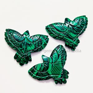 May include: Three green malachite stone carvings of birds. The birds are intricately carved with detailed feathers and wings.