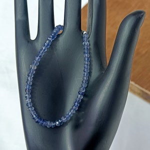 May include: A blue gemstone beaded bracelet with a silver clasp.