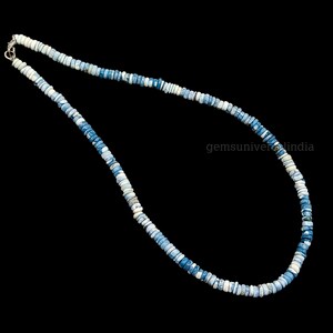 May include: A necklace made of blue and white opal beads. The beads are small and round, and the necklace is about 18 inches long.