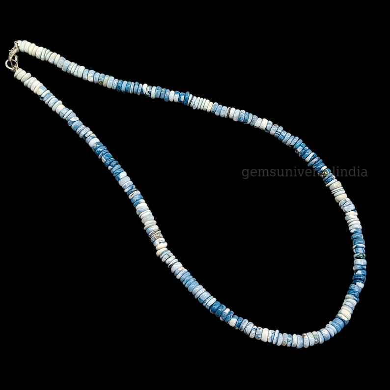 May include: A necklace made of blue and white opal beads. The beads are small and round, and the necklace is about 18 inches long.