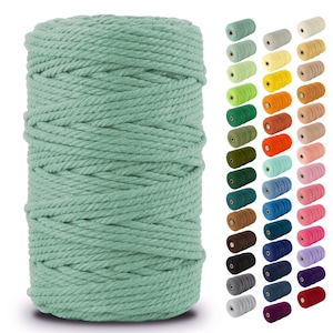 May include: A spool of light green cotton rope, with a variety of colors of the same rope displayed in the background.