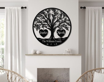 May include: A black metal family tree wall art piece. The tree is in a circular frame with the names "Sophia" and "Noah" in heart-shaped leaves. The family name "The Williams Family" is at the base of the tree.