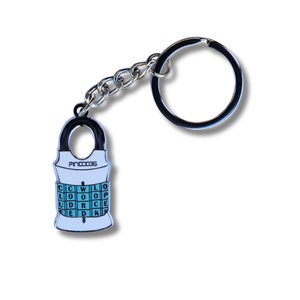 May include: A silver keychain with a white metal charm shaped like a life vest. The charm has the text "PIN CODE" and a grid of letters that spell out "CLOCKWISE" in a turquoise color.