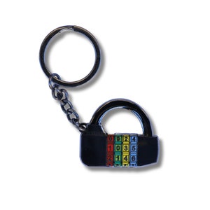 May include: A black metal combination padlock keychain with a silver key ring. The padlock has a combination dial with numbers 0-6 in red, yellow, green, and blue.