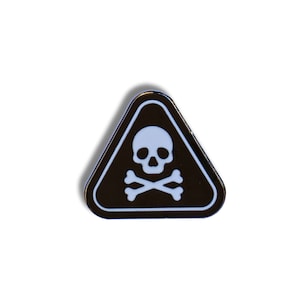 May include: A black and white triangular pin featuring a skull and crossbones symbol. The pin has a white border and a black background. The skull and crossbones are white. The pin is a warning symbol.
