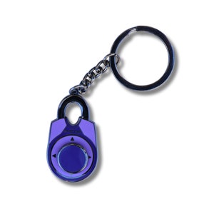 May include: A purple and silver combination lock keychain with a silver key ring. The lock has a dial with arrows pointing in different directions. The lock has the word "UNLOCK" printed on it.