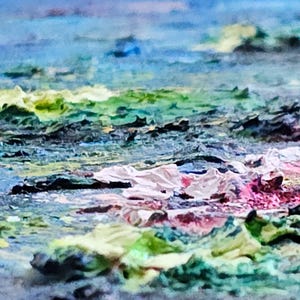 May include: Abstract painting with a textured surface. The artwork features a blend of colors, including blues, greens, pinks, and whites, creating a dynamic and expressive composition. The brushstrokes and textures add depth and visual interest to the piece.