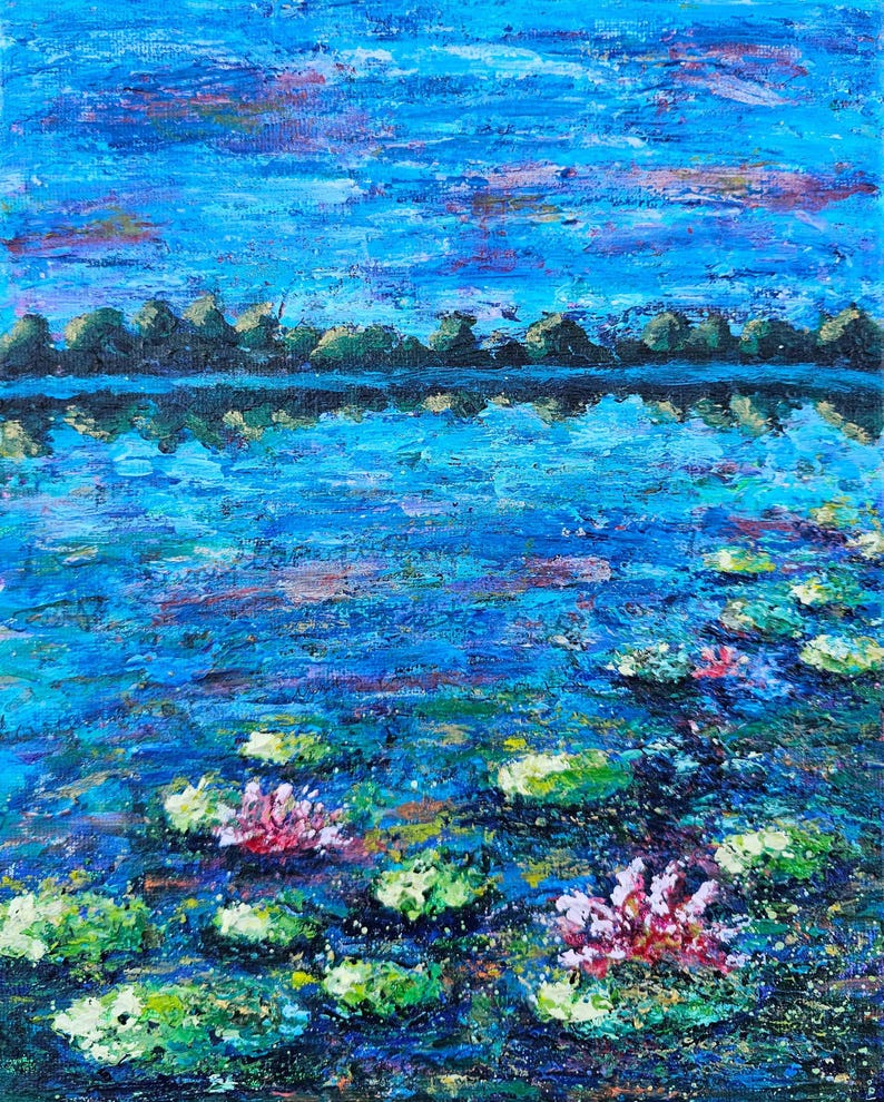 May include: Impressionistic oil painting of a serene lake scene. The artwork features a vibrant blue sky with streaks of pink and purple. The water reflects the sky and a distant treeline. Lily pads and pink water lilies float on the water's surface.