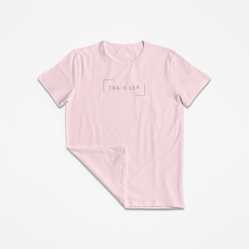 May include: A pink t-shirt with a simple graphic design that says "TRA/E LER" in a box.