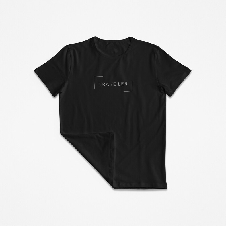May include: Black t-shirt with a white graphic that says "TRA/VELER" inside a box.