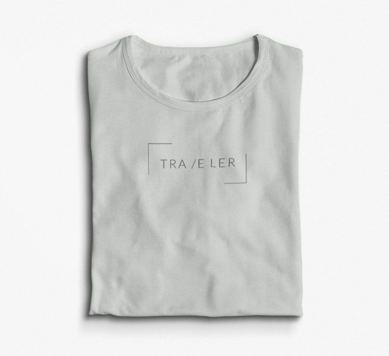 May include: A light gray t-shirt with a simple design featuring the word "TRAVELER" in a box.