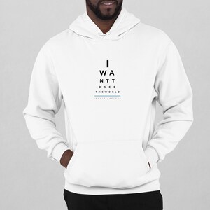 May include: White hooded sweatshirt with black text that reads "I WANT TO SEE THE WORLD" and "INHALE EXPLORE" in a smaller font below.