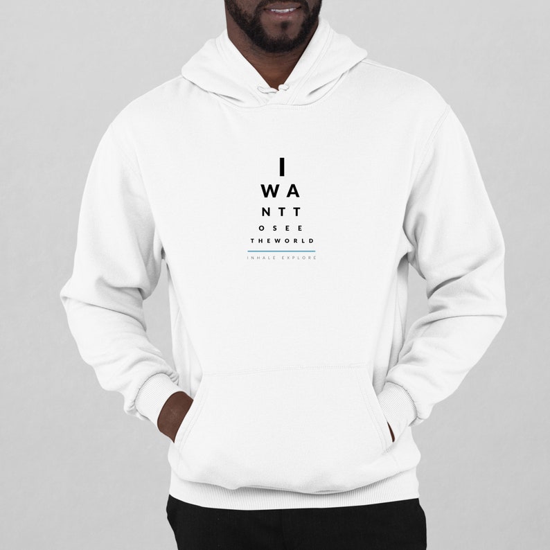 May include: White hooded sweatshirt with black text that reads "I WANT TO SEE THE WORLD" and "INHALE EXPLORE" in a smaller font below.