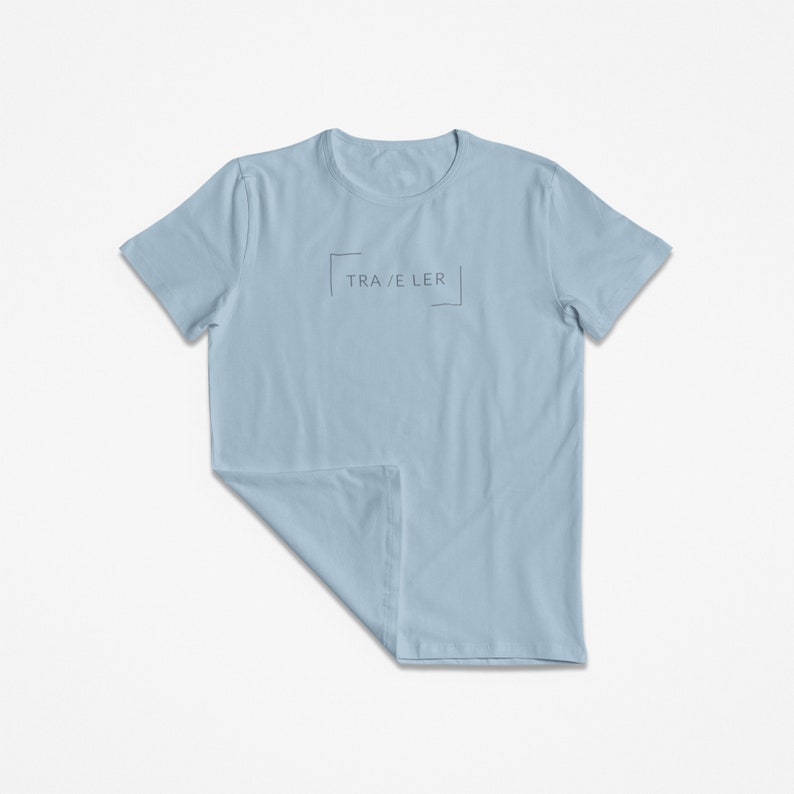 May include: A light blue t-shirt with the text "TRA/E LER" inside a box.