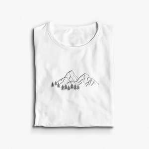 May include: White t-shirt with a black line drawing of mountains and trees.