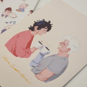 May include: A drawing of two people smiling at each other while holding mugs of coffee. The text "Home Sweet Home" is written in yellow cursive at the bottom of the image.