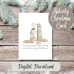 Puede incluir: Una tarjeta navideña blanca con una ilustración en acuarela de la escena de la Natividad, con María, José, Jesús, ovejas y una estrella. La tarjeta tiene el texto "Nativity Christmas Card" y "Digital Download".