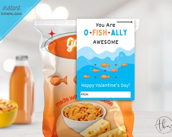May include: A Valentine's Day card with a blue and white ocean scene and the text "You Are O-FISH-ALLY AWESOME Happy Valentine's Day!"  The card is next to a bag of goldfish crackers.