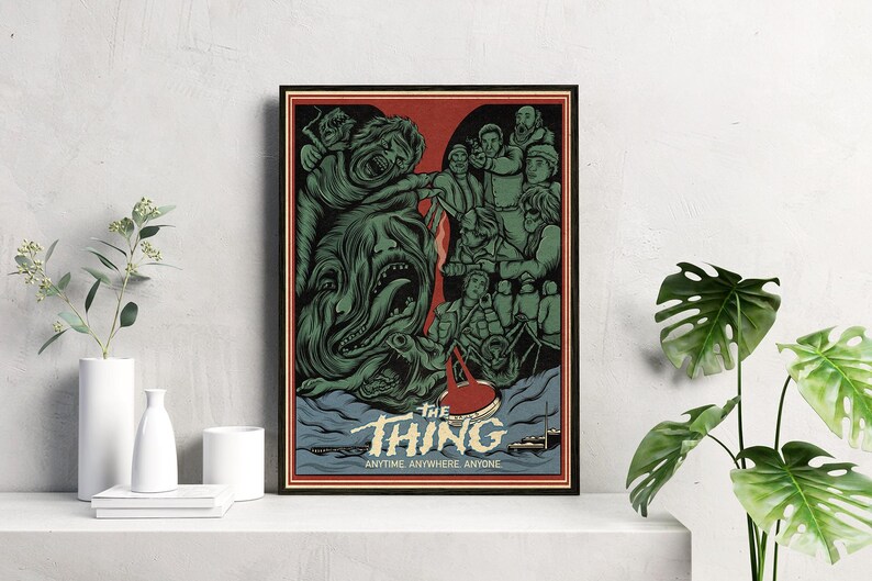 May include: A vintage-style poster for the 1982 horror film "The Thing". The poster features a green, monstrous creature with sharp teeth and a red, bloody handprint. The text on the poster reads "The Thing: Anytime. Anywhere. Anyone."