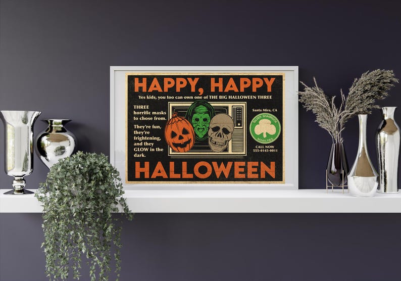 May include: A vintage Halloween poster with a retro design. The poster features a television screen with three Halloween masks, a pumpkin, a green monster, and a skull. The poster is titled "Happy, Happy Halloween" and includes a phone number to call for more information.