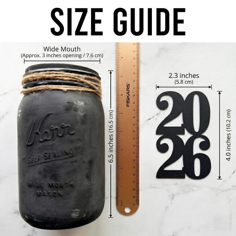 May include: A white ceramic mug with a black handle and the text "But First, Coffee" in a black, bold font. The mug is on a white surface.