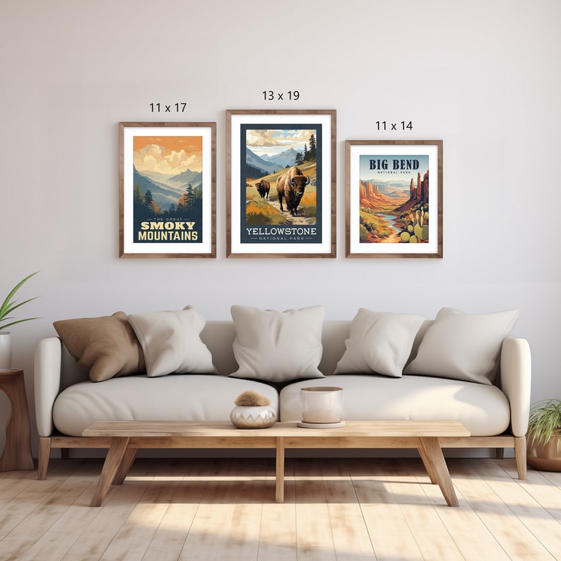 May include: Three framed art prints with nature scenes. The prints are 28 x 43 cm, 33 x 48 cm, and 28 x 36 cm. The prints feature text that reads "The Great Smoky Mountains", "Yellowstone National Park", and "Big Bend". The frames are brown.