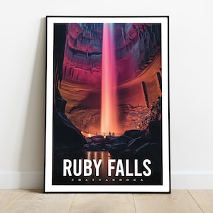 May include: A poster featuring a photograph of Ruby Falls in Chattanooga, Tennessee. The waterfall is illuminated in a vibrant pink and orange light, creating a dramatic and colorful scene.