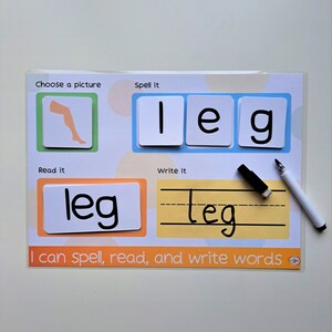 May include: A colorful learning card with a picture of a leg, the word "leg" spelled out with letter tiles, and the word "leg" written in black marker. The card also includes the text "Choose a picture", "Spell it", "Read it", "Write it", and "I can spell, read, and write words".