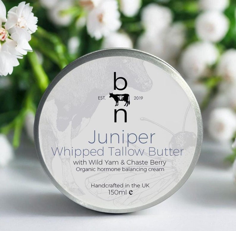 May include: A silver tin of Juniper Whipped Tallow Butter with Wild Yam & Chaste Berry. The tin is labeled with the brand name "bh" and the text "EST. 2019". The tin is 150 ml and handcrafted in the UK.