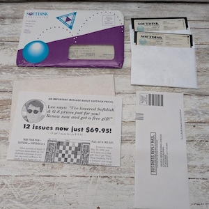 May include: An assortment of vintage Softdisk computer software, including floppy disks and promotional materials. The image features envelopes, a subscription offer, and a business reply mail envelope. The main colors are white, purple, and blue.