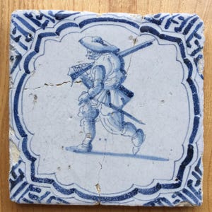 Antique 17th century blue and white Dutch Delft tile with a soldier