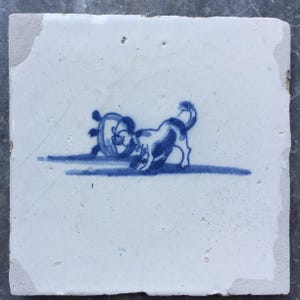 Antique 17th century Dutch Delft tile with saying: the dog in the kettle.