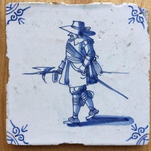 Antique 17th century blue and white Dutch Delft tile with a soldier