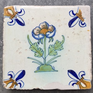 Antique 17th century Dutch Delft tile with buttercup flower