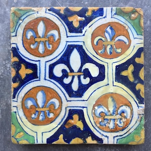 Antique 17th century Dutch Delft tile with the decoration of fleur de lis or French lilies