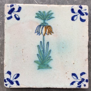 Antique 17th century Dutch Delft tile with imperial crown flower