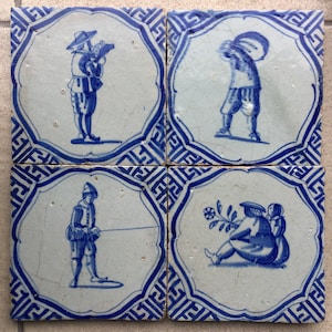 Four antique blue and white Dutch Delft tiles with a figures from the 17th century