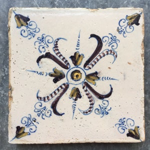 Antique Dutch Delft tile with ornamental design