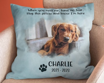May include: A blue throw pillow with a watercolor image of a brown dog. The pillow has the text "When you miss me, have no fear, Hug this pillow and know I'm here" and "CHARLIE 2021-2023".