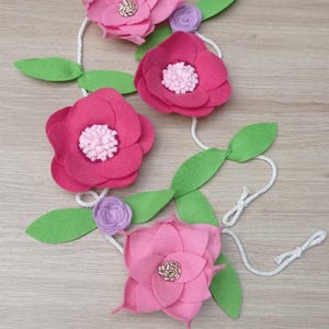 Blumengirlande aus Filz. Dekorative Blumengirlande. Rosa Filzblumen. Girlande zur Hochzeitsdekoration.