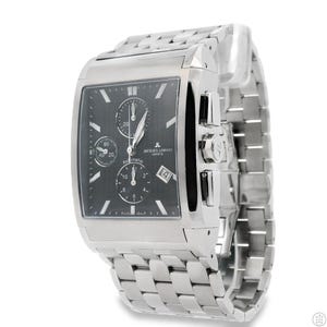 May include: A silver-toned Jacques Lemans Geneve automatic watch with a rectangular black face. The watch features multiple subdials, a date window, and a stainless steel band. The watch is displayed on a white background.