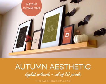 May include: A set of 20 digital prints with an autumn aesthetic. The prints feature a spiderweb, a skull, and a quote about autumn. The prints are displayed on a shelf with a white pumpkin and bats.