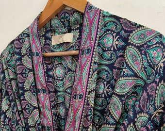 May include: A navy blue silk robe with a paisley pattern and pink and green trim. The robe has a long sleeve and a tie belt.