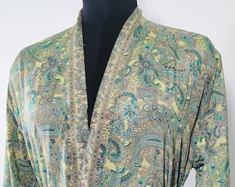 May include: A green and gold paisley patterned robe with a tie belt. The robe is made of a soft, silky fabric.