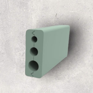 May include: A light green plastic cable organiser with three round holes. The organiser is designed to hold and organise cables.