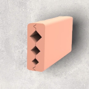 May include: A peach-colored brick with a series of diamond-shaped cutouts on one side.