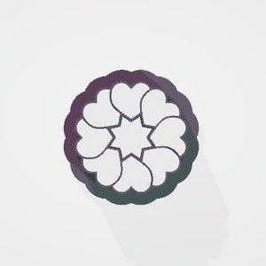 May include: A purple and green heart-shaped cookie cutter. The cutter features a circular design with seven hearts arranged around a central star shape. The cutter is made of plastic and is designed for baking.