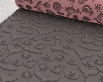 May include: A pink rolling pin with a Halloween-themed pattern is rolled over a gray surface. The pattern includes jack-o'-lanterns, bats, spiders, cats, and other spooky designs. The rolling pin is made of a durable material.