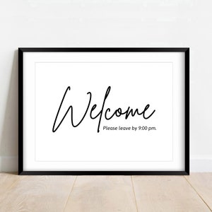 May include: Black framed print with the word "Welcome" written in cursive script. The text below reads "Please leave by 9:00 pm."